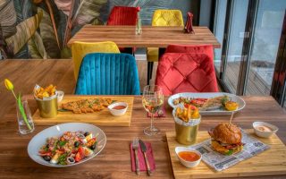 Colorful dining setup in a modern restaurant featuring diverse meals and vivid decor.